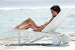 Foto: Woman in chaise-lounge near sea Woman in chaise-lounge near sea