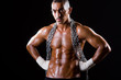 Muscular man with chain on black background