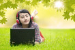 Young girl listening to music on grass