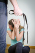 Man with belt coming to his wife. Home violence concept