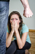 Frightened woman and men's fist