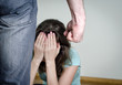 Home violence concept. Frightened woman and men's fist