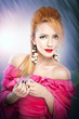 blond girl in pink  dress with hairstyle applying perfume