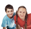 The girl and the boy teenagers look out from round the corner