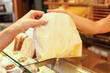 Baker's shop shopkeeper gives bread to customer