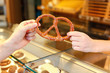 Shopkeeper in bakery sells pretzel