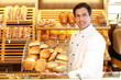 Shopkeeper with basket of bread