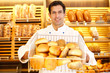 Shopkeeper with basket of bread