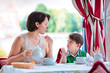 Mother and son having breakfast together