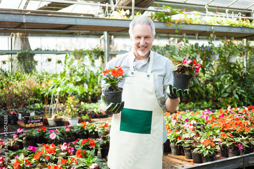 Photo: Man holding flower pots Man holding flower pots