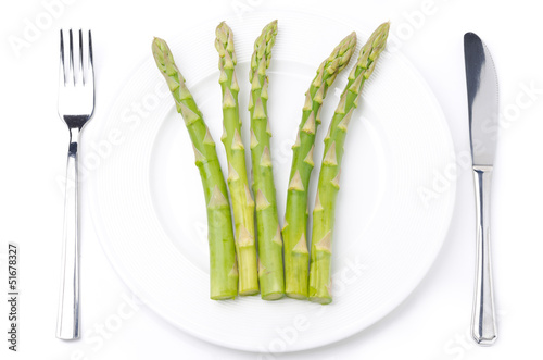 Photo: dietetic food - asparagus on a plate, concept, isolated on white dietetic food - asparagus on a plate, concept, isolated on white