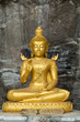 Buddha on stone babkground in cave of Thailand