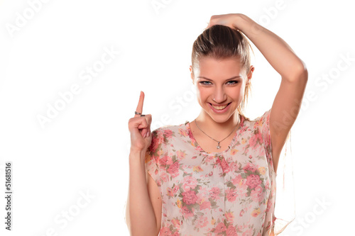 Photo: teenage girl in dress pointing a finger at a blank teenage girl in dress pointing a finger at a blank