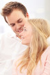 Photo: Portrait of a happy couple sitting together Portrait of a happy couple sitting together