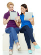 Foto: Two girls learning together with touchpad for school Two girls learning together with touchpad for school