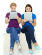 Foto: Two girls learning together with touchpad for school Two girls learning together with touchpad for school