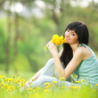 Cute woman in the park with dandelions