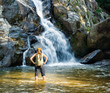 Female hiker looking at waterfall