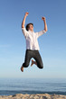 Boy jumping happy on the beach