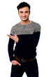 Photo: Casual young guy pointing away Casual young guy pointing away