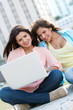Girls social networking on a laptop