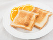 Photo: Unbuttered toast on white plate garnished with orange slices Unbuttered toast on white plate garnished with orange slices