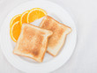 Photo: Unbuttered toast on white plate garnished with orange slices Unbuttered toast on white plate garnished with orange slices