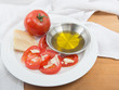 Photo: Plate of vine ripened red tomato with parmesan and olive oil Plate of vine ripened red tomato with parmesan and olive oil