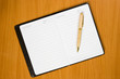 Notebook and pen on the  wooden table