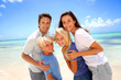 Happy couple with kids at the beach
