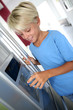 Foto: Young boy drinking water from fridge Young boy drinking water from fridge