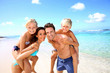 Family of four having fun at the beach