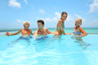 Family of four bathing in swimming pool
