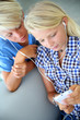 Teenagers using smartphone with earphones