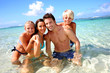 Couple and children in crystal clear water Couple and children in crystal clear water