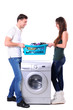 beautiful young couple with a washing machine