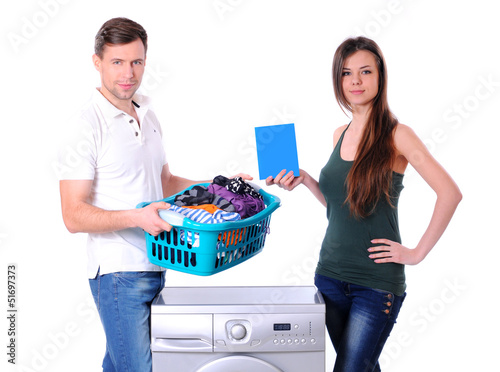 Photo: beautiful young couple with a washing machine beautiful young couple with a washing machine
