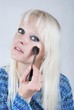 Woman applying makeup