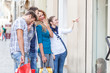 Happy Girls With Bored Boys on Shopping