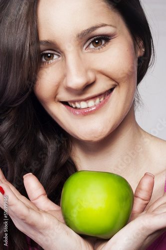 Photo: Young happy woman with an apple Young happy woman with an apple