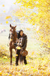 Photo: equestrian with her horse in autumnal nature equestrian with her horse in autumnal nature