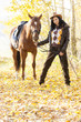 Photo: equestrian with her horse in autumnal nature equestrian with her horse in autumnal nature