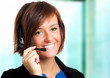 Photo: Female call center employee wearing a headset Female call center employee wearing a headset