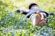 Photo: Mädchen liegt in einer blauen Blumenwiese Mädchen liegt in einer blauen Blumenwiese