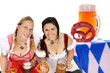 Foto: two woman in dirndl with beer mug and pretzel two woman in dirndl with beer mug and pretzel