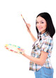Beautiful young woman painter with brushes and palette at work,
