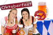Foto: two woman in dirndl with beer mug and pretzel two woman in dirndl with beer mug and pretzel