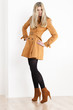 Photo: standing woman wearing coat and fashionable brown shoes standing woman wearing coat and fashionable brown shoes