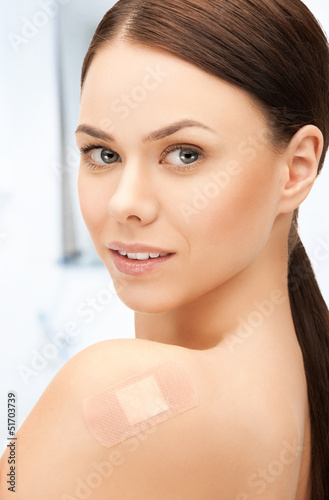 Photo: beautiful woman with medical patch or plaster beautiful woman with medical patch or plaster