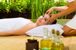 Foto: Asian woman having a massage in tropical setting Asian woman having a massage in tropical setting